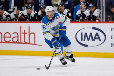 St. Louis Blues defenseman Justin Faulk skates with the puck during 2025 game.